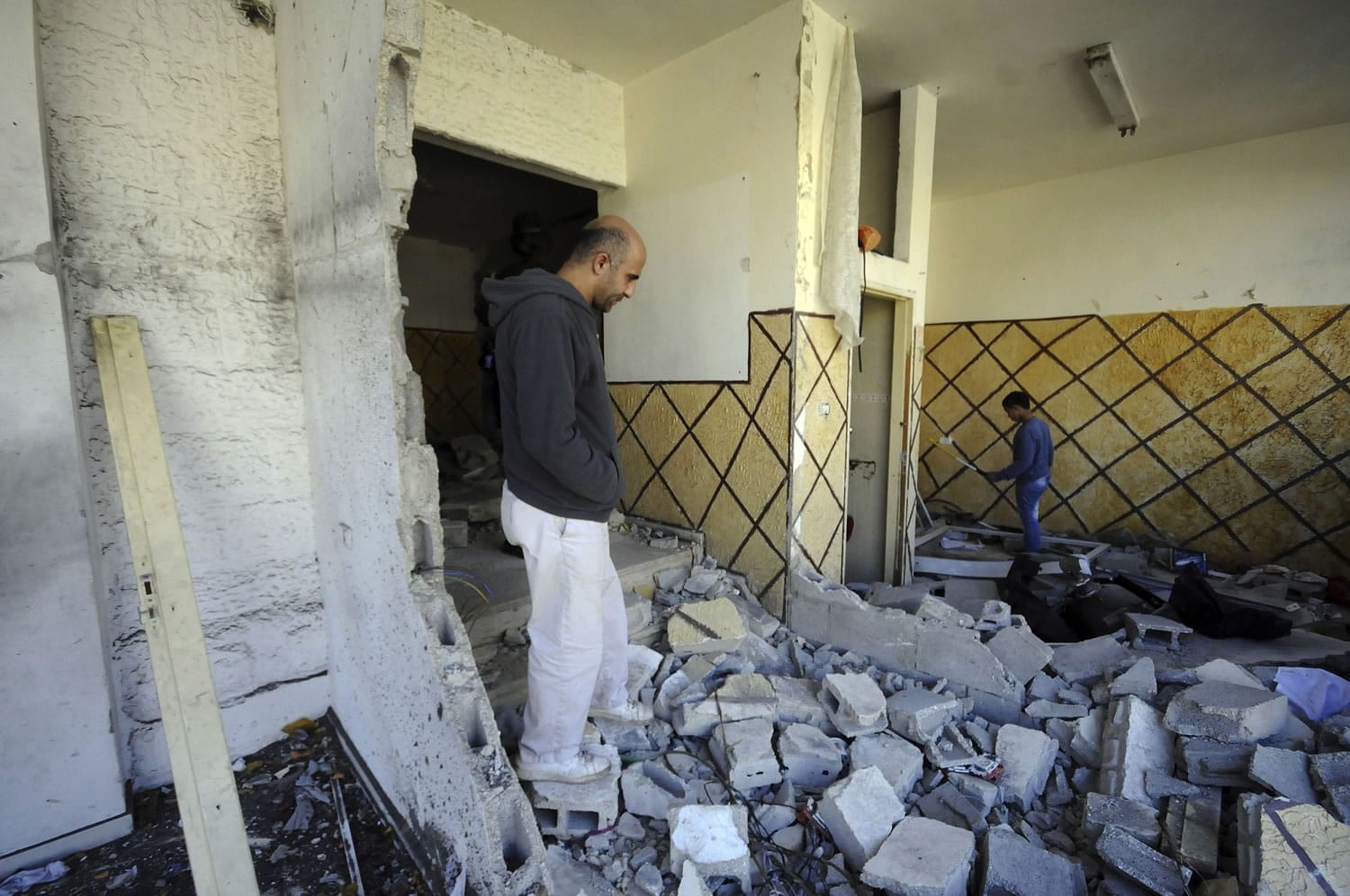 Palestinians inspect the demolished apartment of Abdel Rahman al-Shaludi on Wednesday in east Jerusalem.