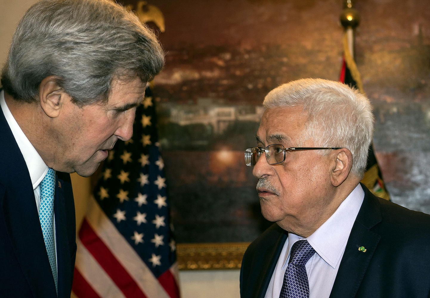 U.S. Secretary of State John Kerry, left, speaks with Palestinian President Mahmoud Abbas in Amman, Jordan, Thursday, Nov. 13, 2014.