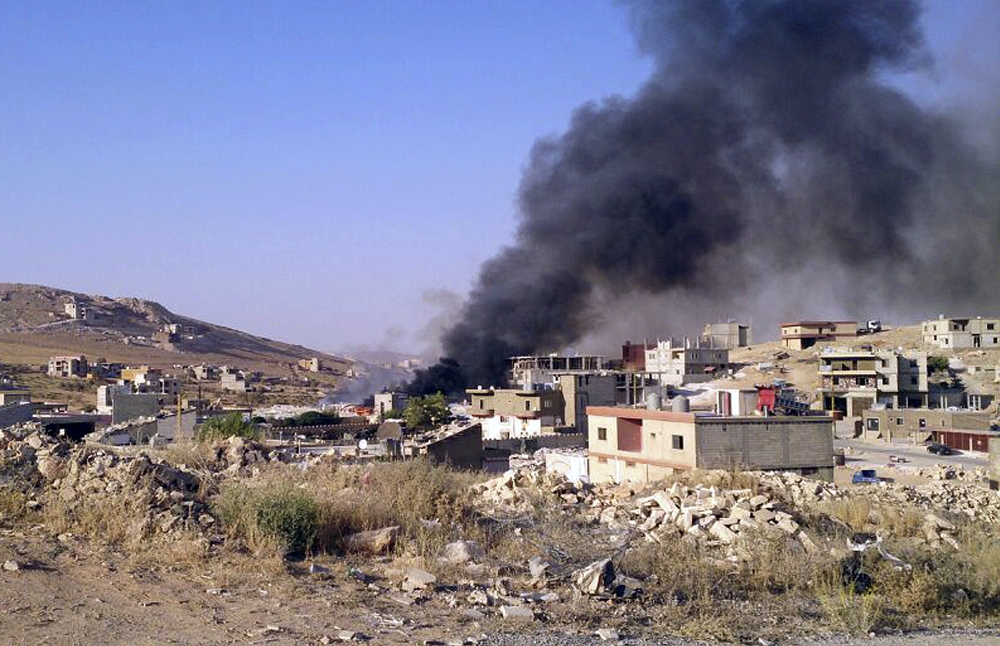 Associated Press
Smoke billows Saturday from Arsal, a Sunni Muslim town near the Syrian border in eastern Lebanon.