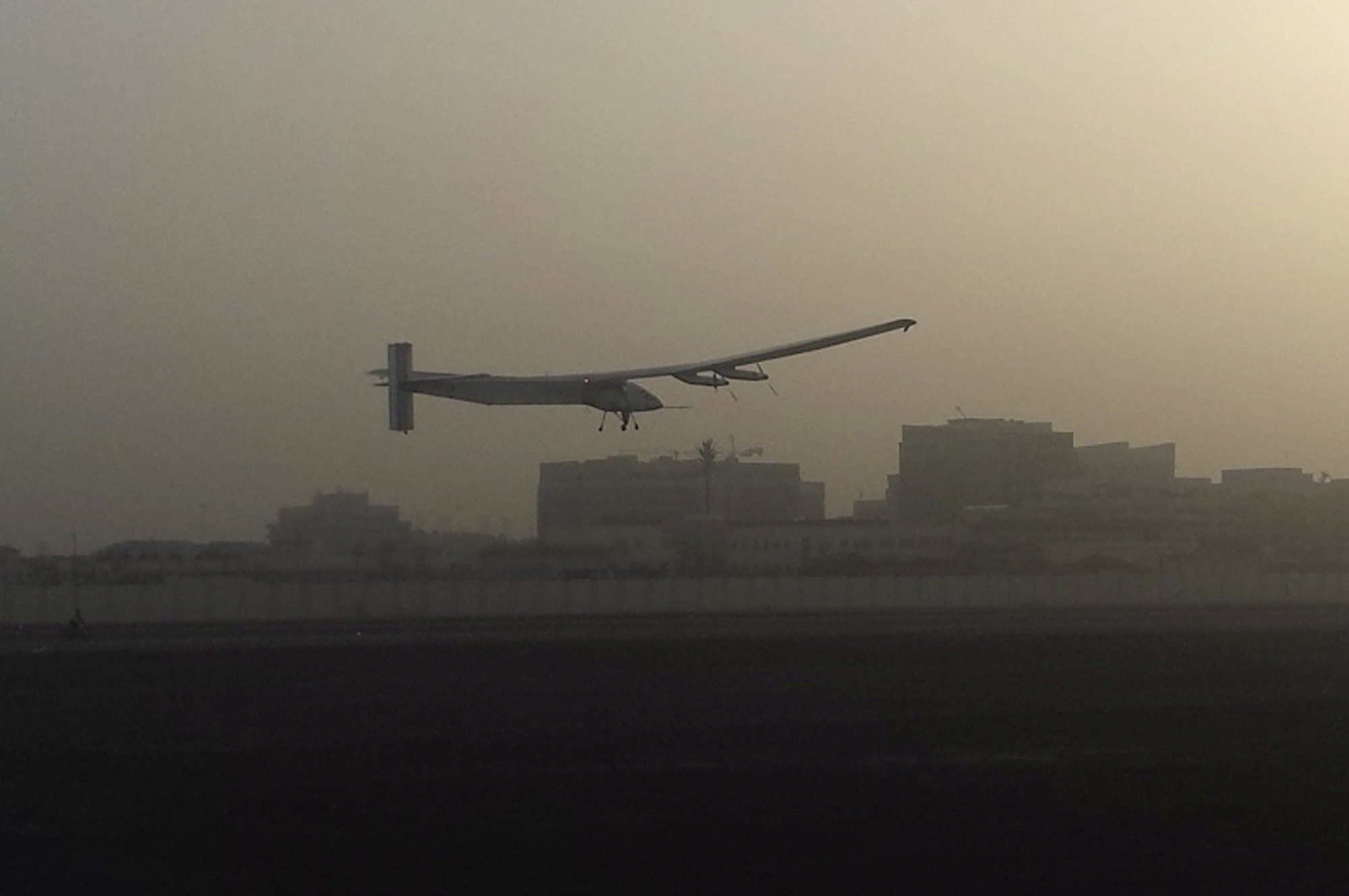 A Swiss solar-powered plane takes off at an airport in Abu Dhabi, United Arab Emirates, early Monday,, marking the start of the first attempt to fly around the world without a drop of fuel.