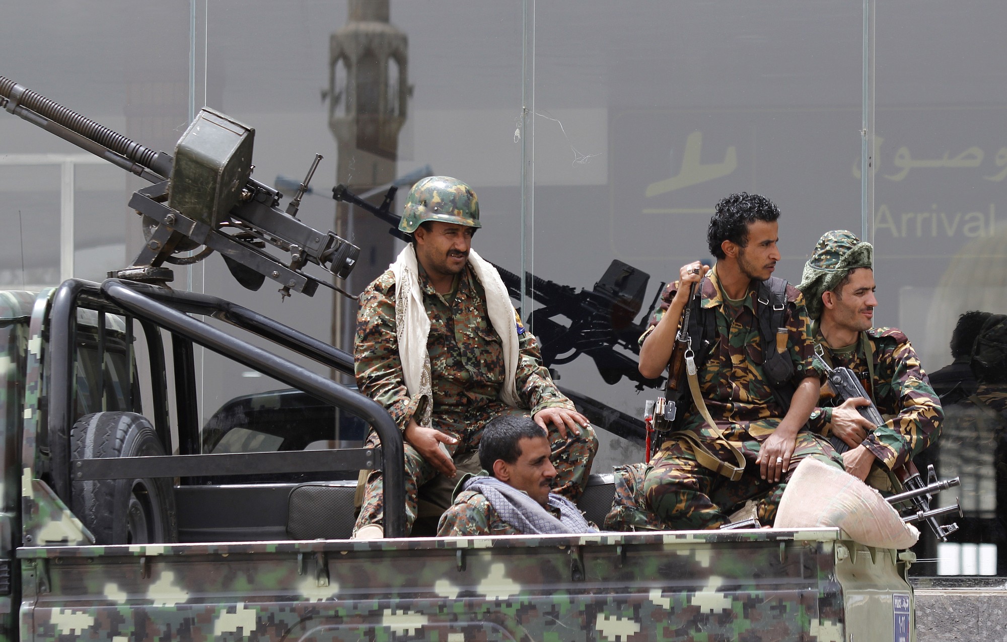 Shiite rebels, known as Houthis, wearing an army uniform, ride on an armed truck to patrol the international airport in Sanaa, Yemen, Saturday, March 28, 2015. Yemen's President Abed Raboo Mansour Hadi, speaking at an Arab summit in Egypt on Saturday, called Shiite rebels who forced him to flee the country &quot;puppets of Iran,&quot; directly blaming the Islamic Republic for the chaos there and demanding airstrikes against rebel positions continue until they surrender.