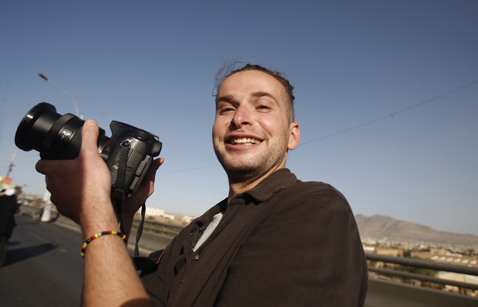 Luke Somers, 33, takes photos during a parade marking the second anniversary of the revolution in Sanaa, Yemen, on Feb.