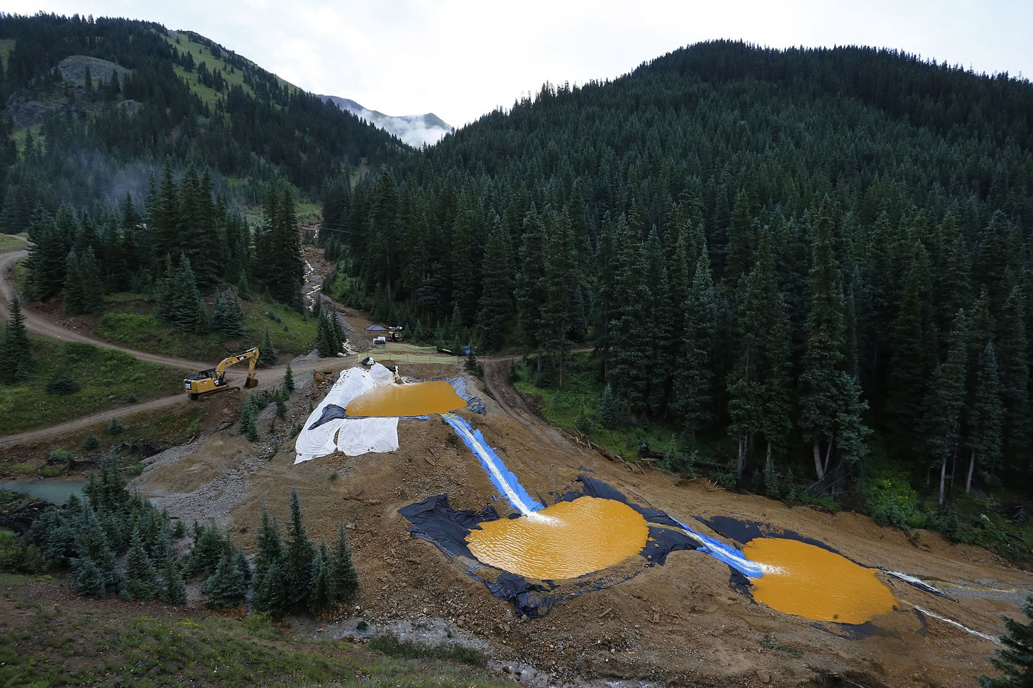 Water flows through a series of retention ponds built to contain and filter out heavy metals and chemicals from the Gold King mine chemical accident, in the spillway about 1/4 mile downstream from the mine, outside Silverton, Colo.