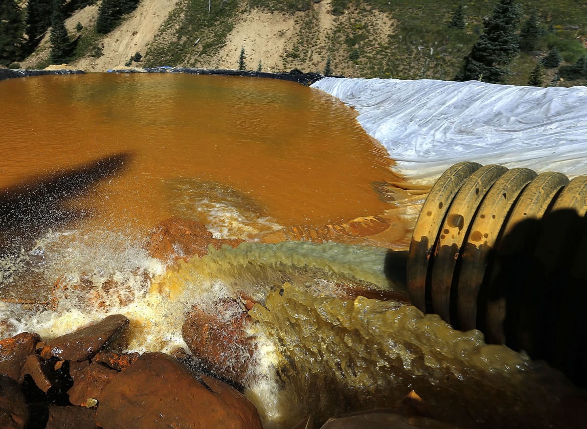 Water flows through a series of sediment retention ponds built to reduce heavy metal and chemical contaminants from the Gold King Mine wastewater accident, in the spillway about a quarter-mile downstream from the mine, outside Silverton, Colo., Friday.
