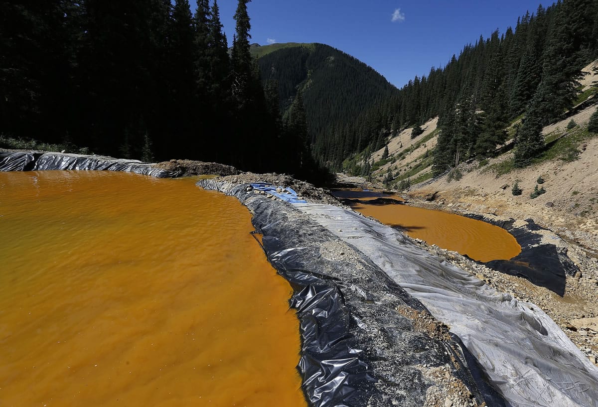 Water flows through a series of sediment retention ponds built to reduce heavy metal and chemical contaminants from the Gold King Mine wastewater accident, in the spillway about 1/4 mile downstream from the mine, outside Silverton, Colo., Friday, Aug. 14, 2015. Officials have said that federal contractors accidentally released more than 3 million gallons of wastewater laden with heavy metals last week at the Gold King Mine near Silverton. The pollution flowed downstream to New Mexico and Utah.