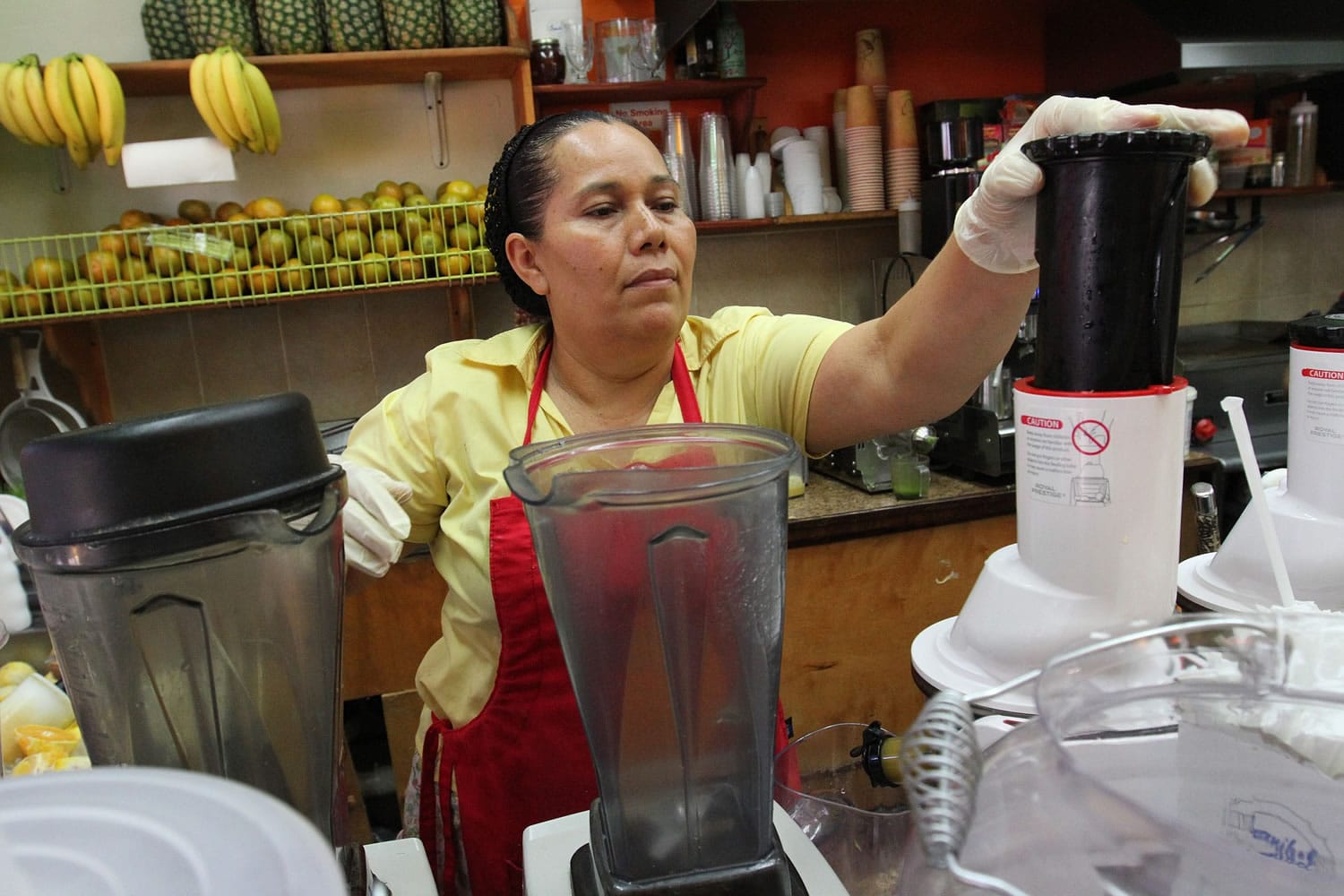 Celina Alvarez, 51, works at Jugueria de regreso al Eden, her shop in the Queens borough of New York, on Aug. 3.