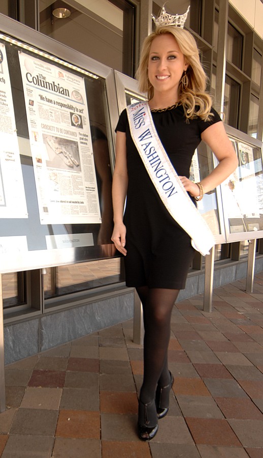 Miss Washington, Jacquie Brown of Vancouver, poses with Tuesday's Columbian front page at the Newseum in Washington, D.C.