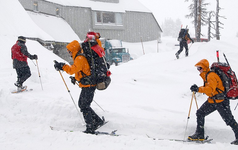 Members of the 304th Rescue Squadron leave the parking lot at Timberline on their way up the slopes of Mt.