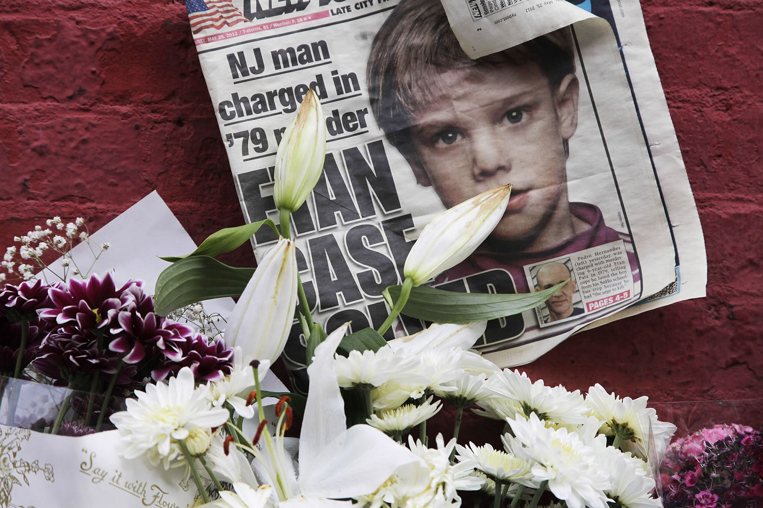 A newspaper with a photograph of Etan Patz sits May 28, 2012, at a makeshift memorial in the SoHo neighborhood of New York where Patz lived before his disappearance on May 25, 1979. The murder trial of Pedro Hernandez, the man accused in the child's disappearance, ended Friday with the jury hopelessly deadlocked after 18 days of deliberations, leaving unresolved a case that has haunted New York City for 36 years.