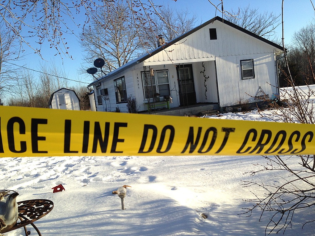 Police tape surrounds one of the crime scenes in Tyrone, Mo., on Friday.