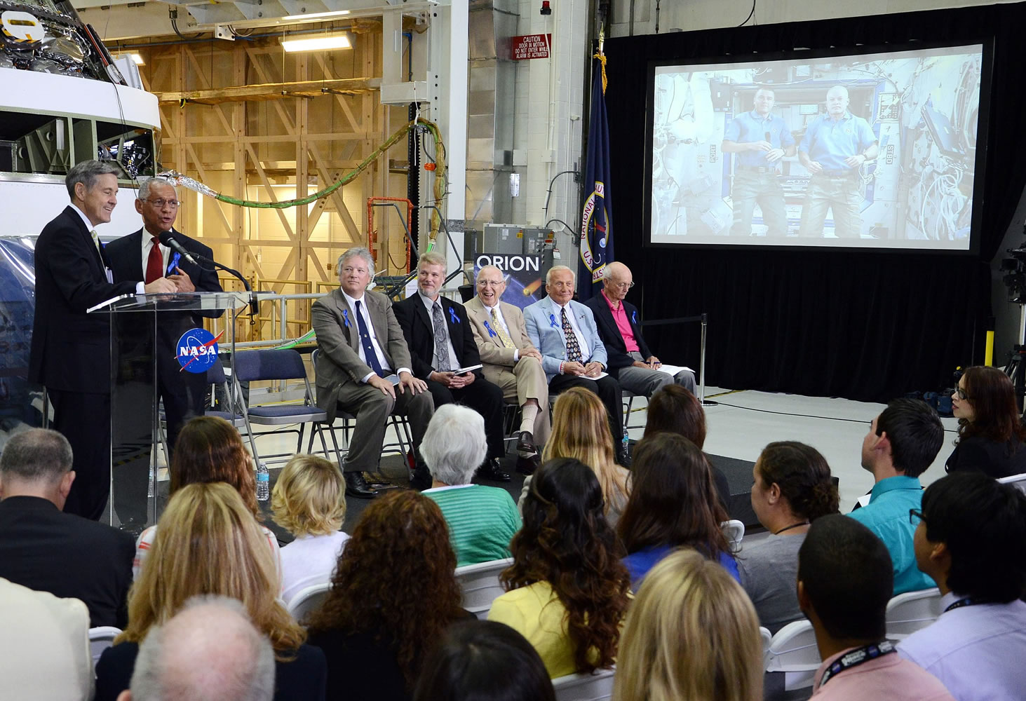 Kennedy Space Center Director Robert Cabana, left, and NASA Administrator Charles Bolden talk with International Space Station astronauts Steve Swanson and Reid Wiseman during a ceremony Monday in the Operations and Checkout building at Kennedy Space Center, Fla., to rename the building in astronaut Neil Armstrongu2019s honor.