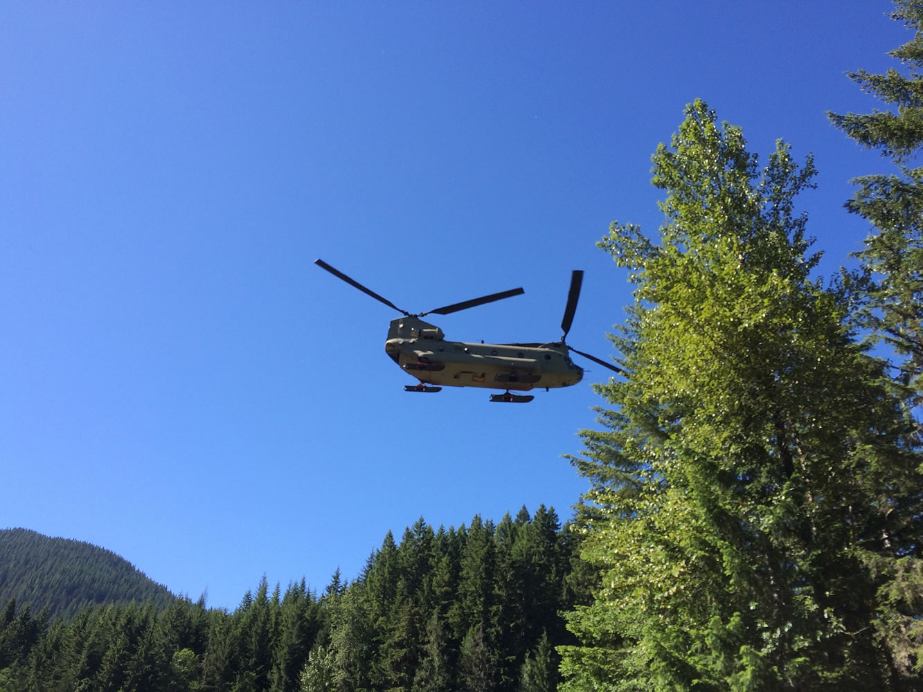 In this photo provided by the National Park Service, a U.S. Army Reserve 214th Air Division Chinook is used to search for missing Utah climber, Kyle Bufis, on Mount Rainier, Saturday, June 13, 2015, at Mount Rainier National Park, Wash. The search was called off Saturday afternoon after a helicopter spotted the body of a deceased male climber near the summit.