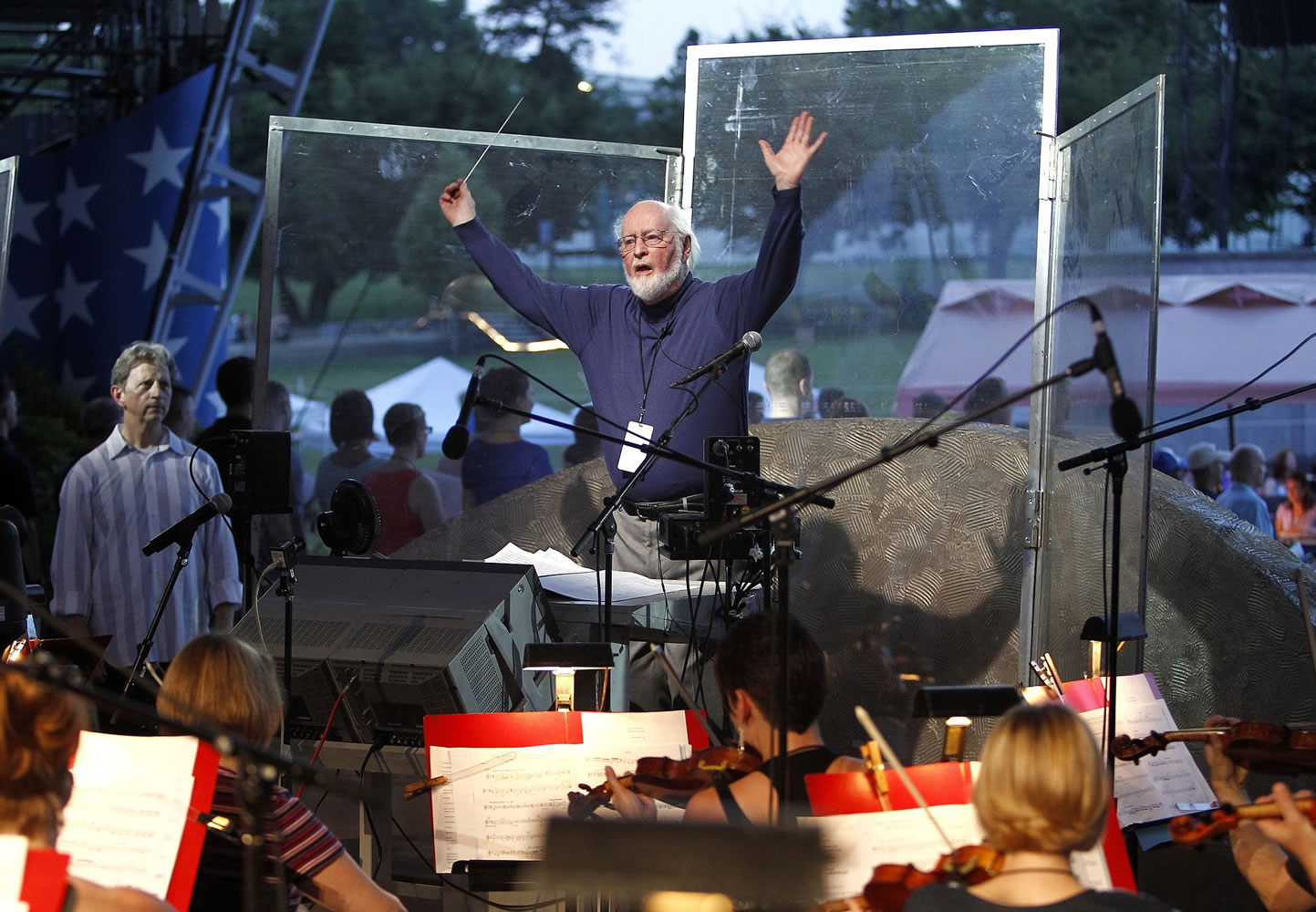 John Williams conducts the National Symphony Orchestra and other musicians for the upcoming debut of a new arrangement of the national anthem, on Capitol Hill in Washington on July 2.