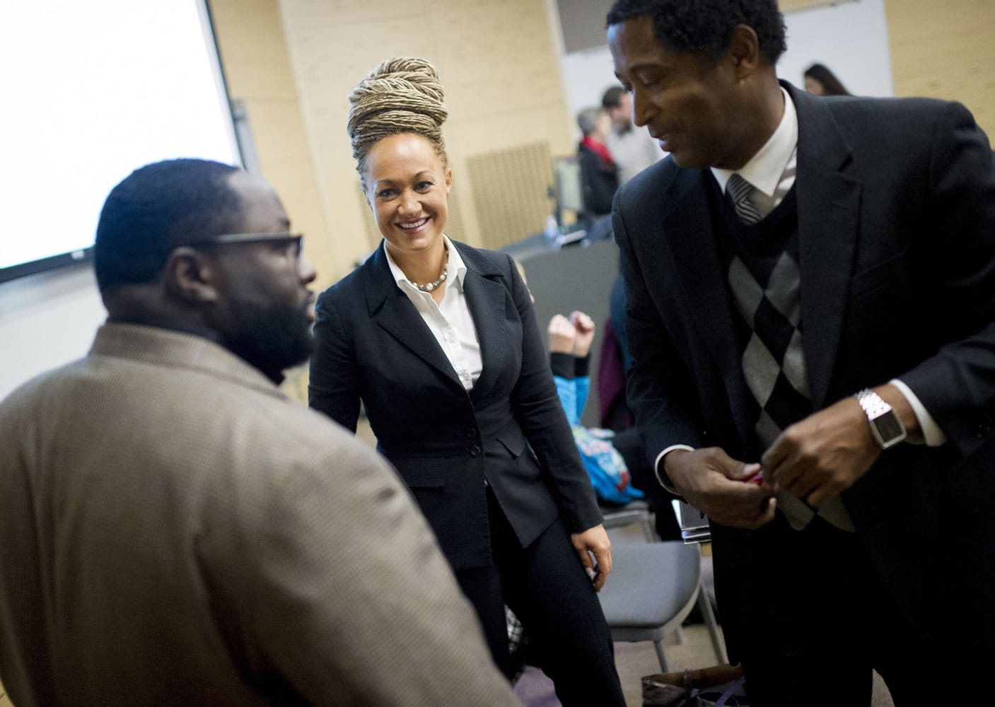 Rachel Dolezal, center, Spokane's newly-elected NAACP president, smiles as she meets with Joseph M.