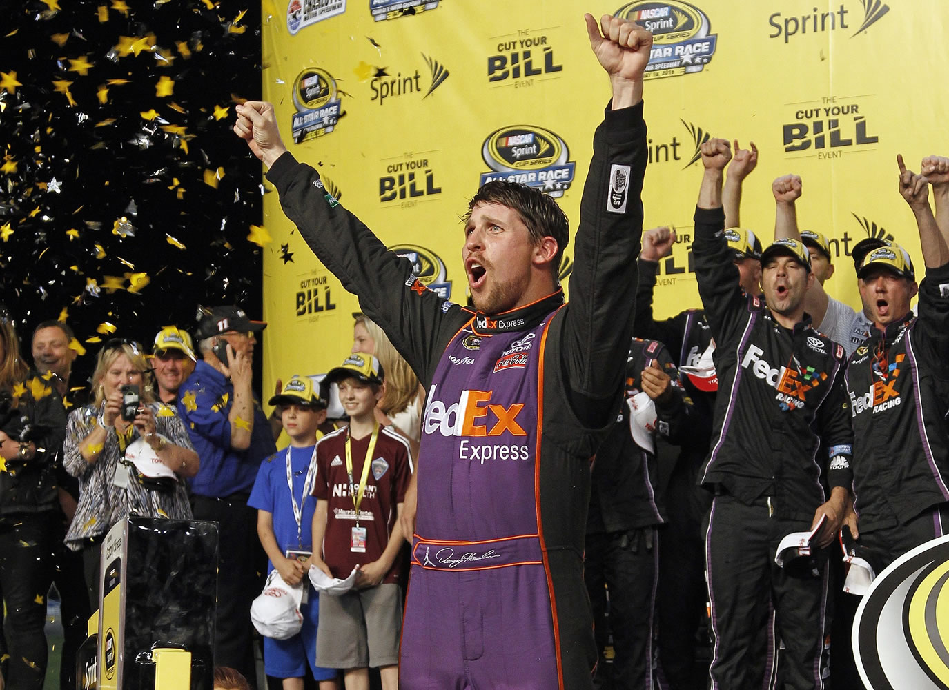 Denny Hamlin celebrates in Victory Lane after winning the NASCAR Sprint All-Star auto race at Charlotte Motor Speedway in Concord, N.C., Saturday, May 16, 2015.