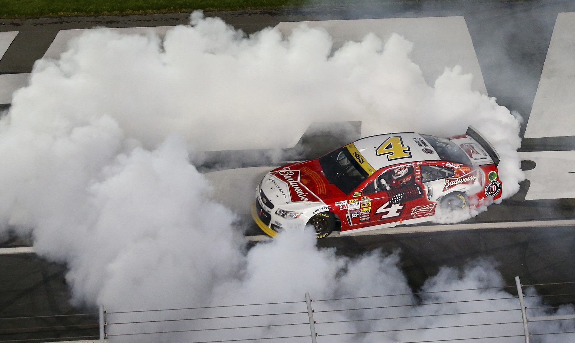 Kevin Harvick (4) burns out after winning the NASCAR Sprint Cup series Bank of America 500 auto race at Charlotte Motor Speedway in Concord, N.C., Saturday, Oct. 11, 2014.