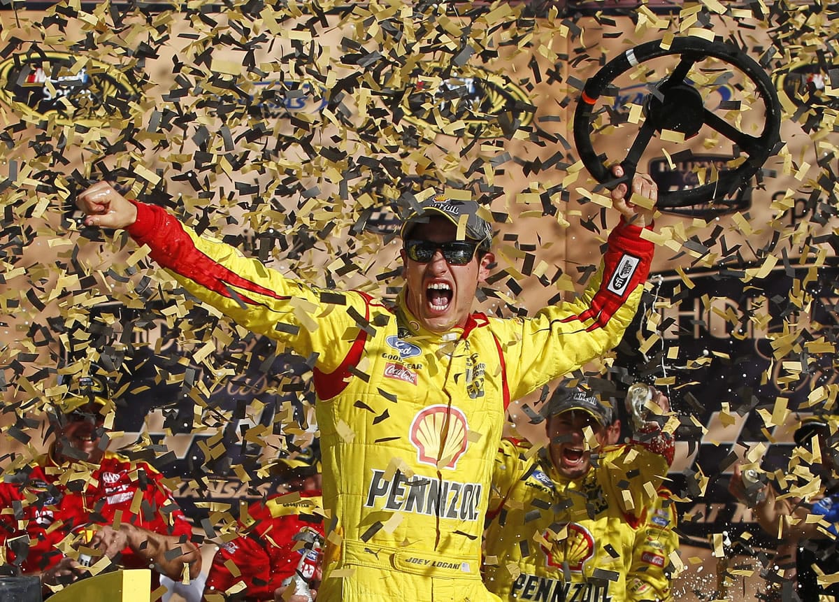 NASCAR Sprint Cup Series driver Joey Logano celebrates his victory in the Hollywood Casino 400 at Kansas Speedway in Kansas City, Kan., Sunday, Oct. 5, 2014. (AP Photo/Colin E.