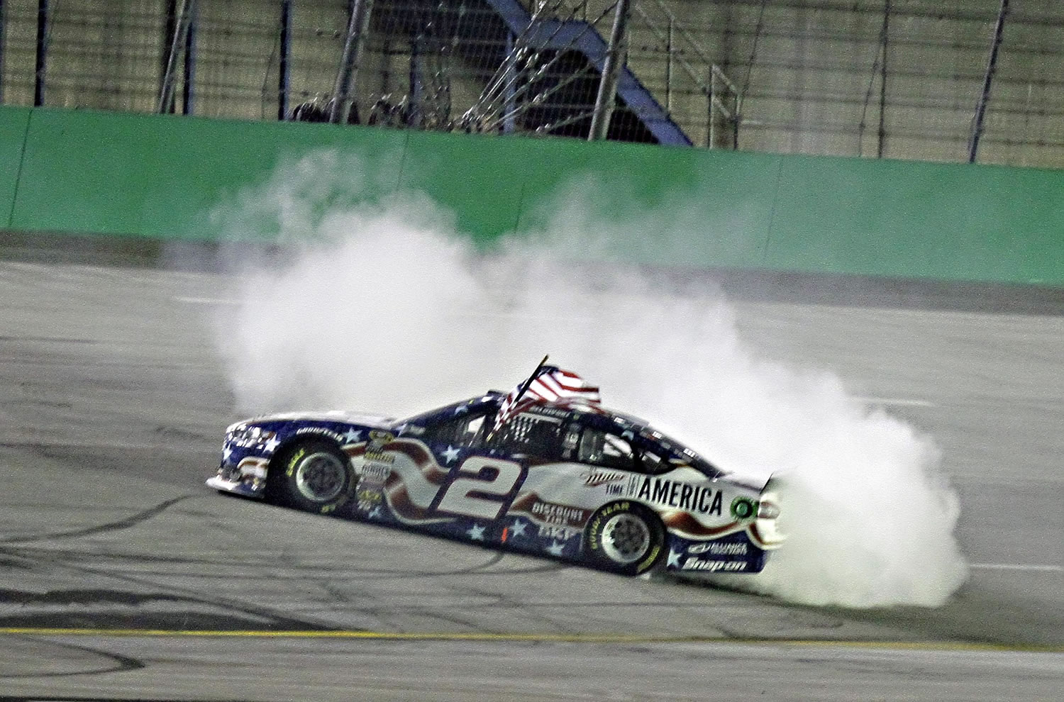 Brad Keselowski does a burnout after winning the NASCAR Sprint Cup series auto race Saturday, June 28, 2014, at Kentucky Speedway in Sparta, Ky.