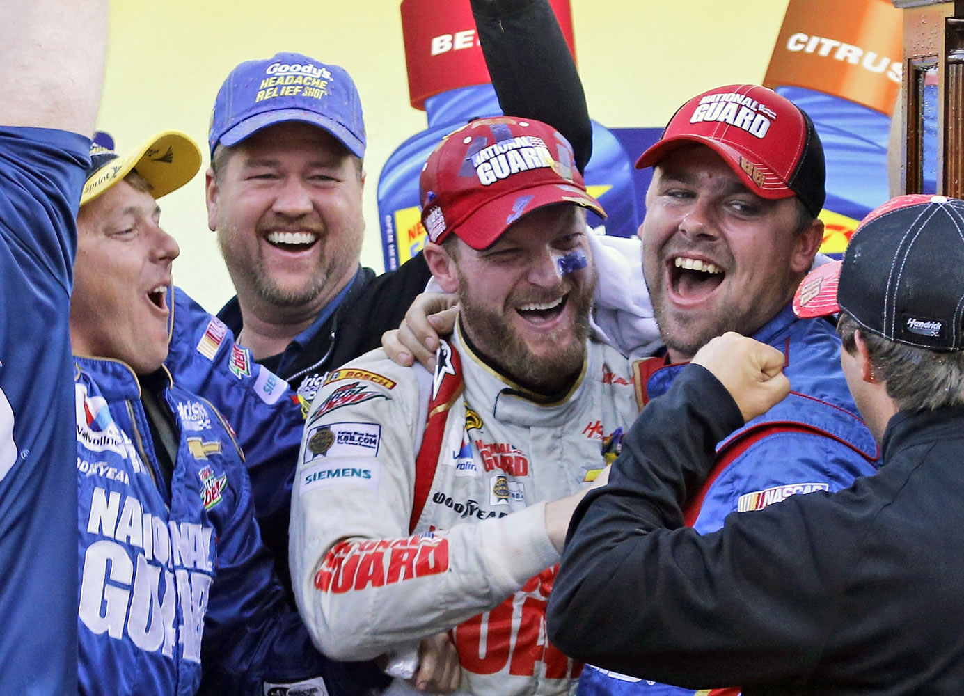 Dale Earnhardt Jr., center, celebrates with his pit crew after winning the NASCAR Sprint Cup Series auto race at Martinsville Speedway in Martinsville, Va., Sunday, Oct. 26, 2014.