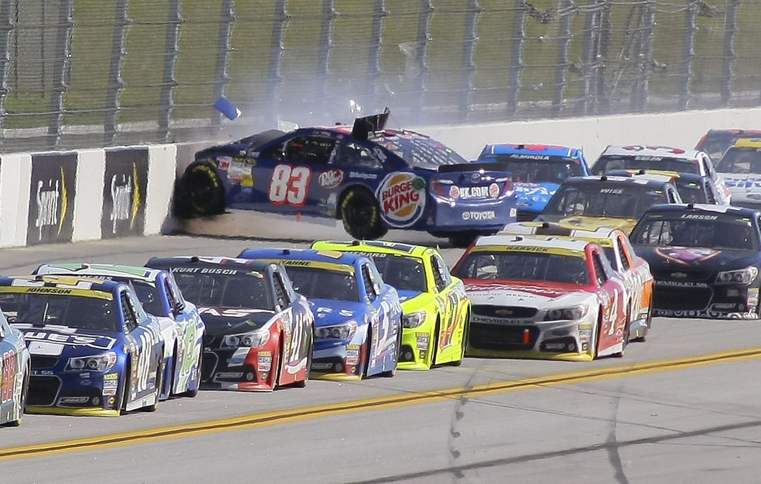 J.J. Yeley (83) wrecks on the backstretch during the NASCAR Sprint Cup Series auto race at Talladega Superspeedway, Sunday, Oct. 19, 2014, in Talladega, Ala.