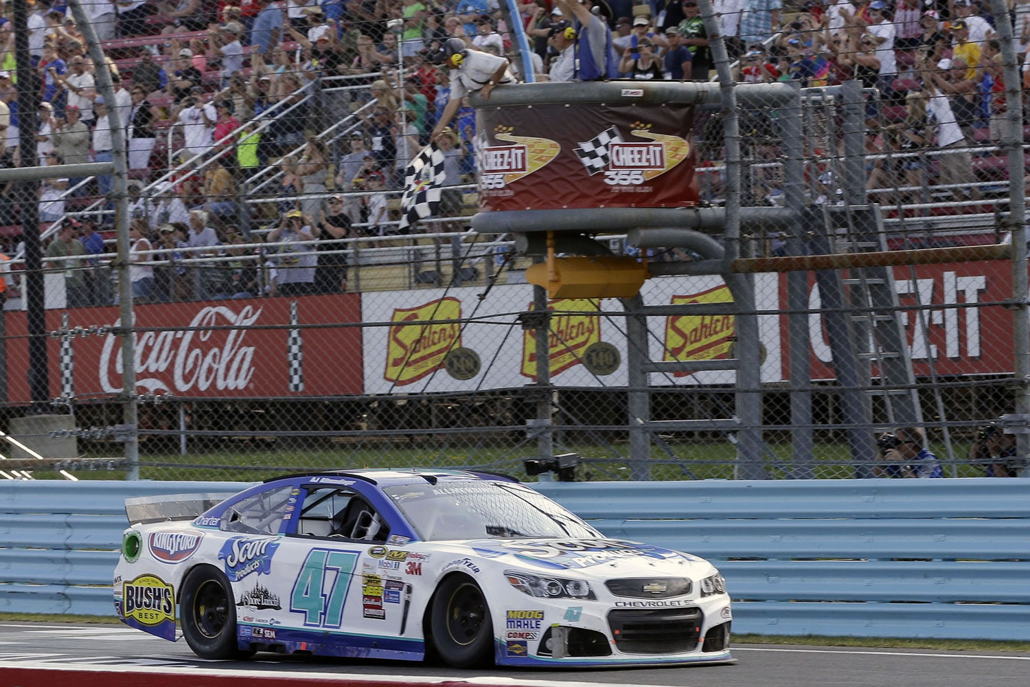 AJ Allmendinger (47) takes the checkered flag to win a NASCAR Sprint Cup Series auto race at Watkins Glen International, Sunday, Aug. 10, 2014, in Watkins Glen N.Y.