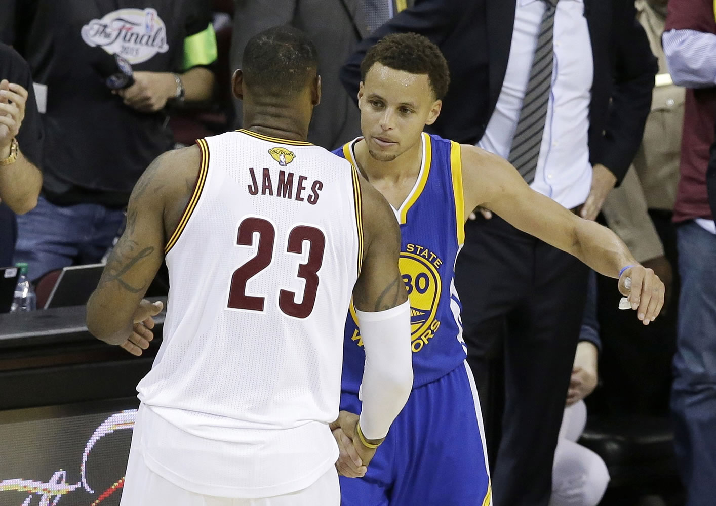 Cleveland Cavaliers forward LeBron James (23) hugs Golden State Warriors guard Stephen Curry (30) during the second half of Game 6 of basketball's NBA Finals in Cleveland, Tuesday, June 16, 2015. The Warriors defeated the Cavaliers 105-97 to win the best-of-seven game series 4-2.