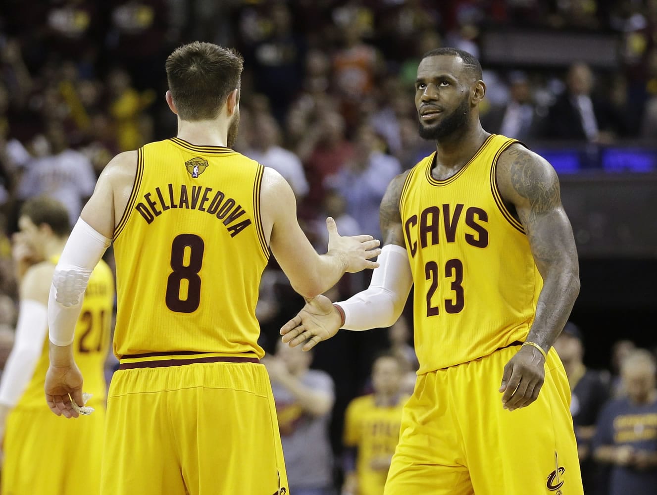 Cleveland Cavaliers forward LeBron James (23) celebrates with teammate Matthew Dellavedova during the second half of Game 3 of the NBA Finals against the Golden State Warriors in Cleveland, Tuesday.