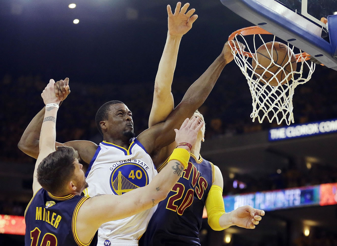 Golden State Warriors forward Harrison Barnes (40) dunks over Cleveland Cavaliers guard Mike Miller, left, and center Timofey Mozgov during the second half of Game 5 of the NBA Finals in Oakland, Calif., on Sunday, June 14, 2015.