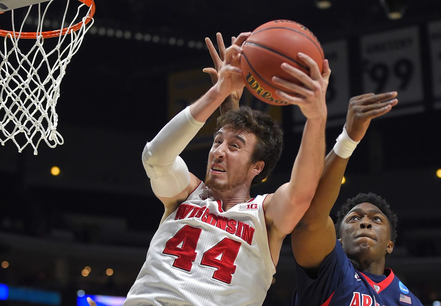 Wisconsin's Frank Kaminsky (44) grabs a rebound in front of Arizona's Stanley Johnson during the first half of the West regional final in the NCAA Tournament, Saturday, March 28, 2015, in Los Angeles. (AP Photo/Mark J.