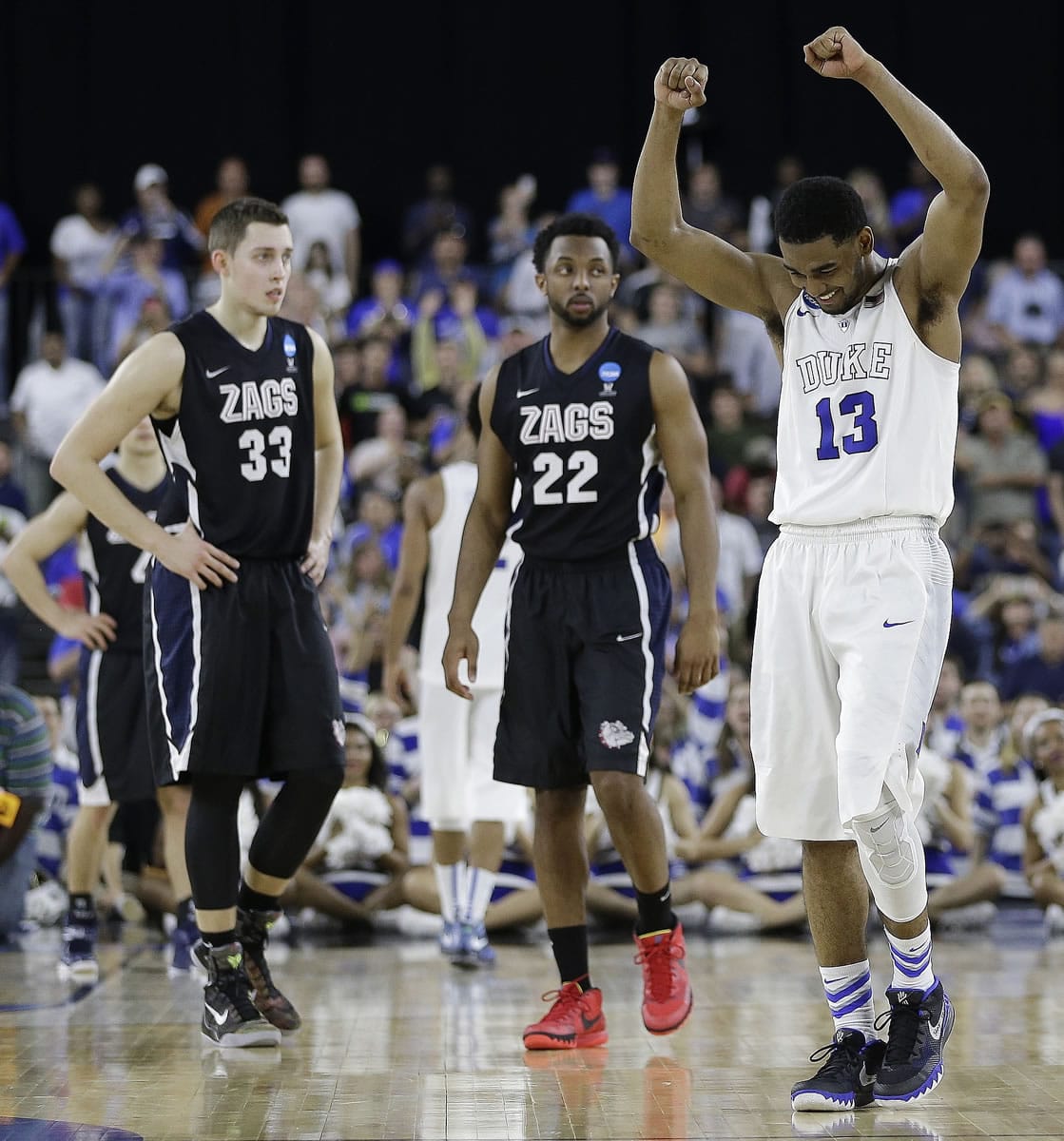 Gonzaga's Kyle Wiltjer (33) and Byron Wesley (22) can only watch as time runs out, while Duke's Matt Jones celebrates the Blue Devils' 66-52 win in the South Regional final on Sunday, March 29, 2015, in Houston. (AP Photo/David J.