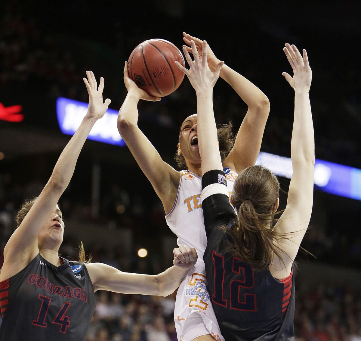 Tennessee's Cierra Burdick, center, shoots against Gonzaga's Sunny Greinacher (14) and Emma Wolfram (12) during the first half of the regional semifinal game in the NCAA tournament, Saturday, March 28, 2015, in Spokane.