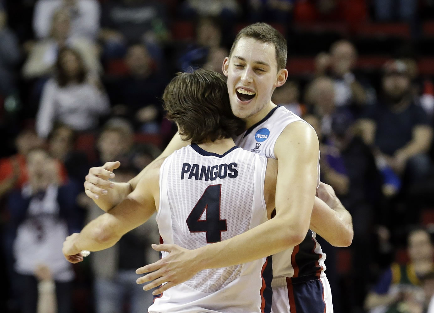 Gonzaga's Kyle Wiltjer, right, embraces Kevin Pangos after the Bulldogs beat Iowa in an NCAA tournament game in Seattle, Sunday, March 22, 2015. Gonzaga won 87-68.