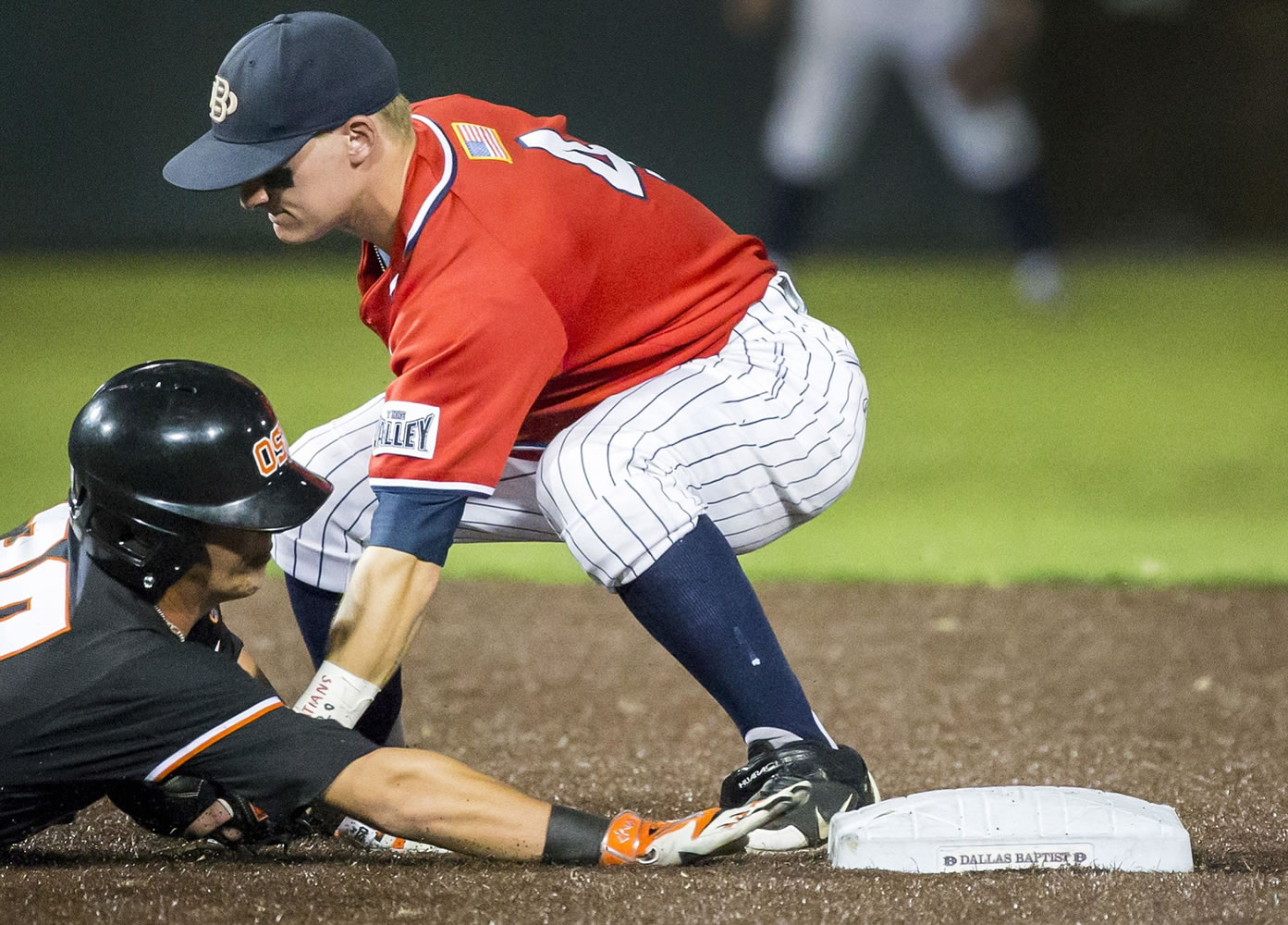 Dallas Baptist shortstop Camden Duzenack tags out Oregon State's Michael Howard at second base Sunday.