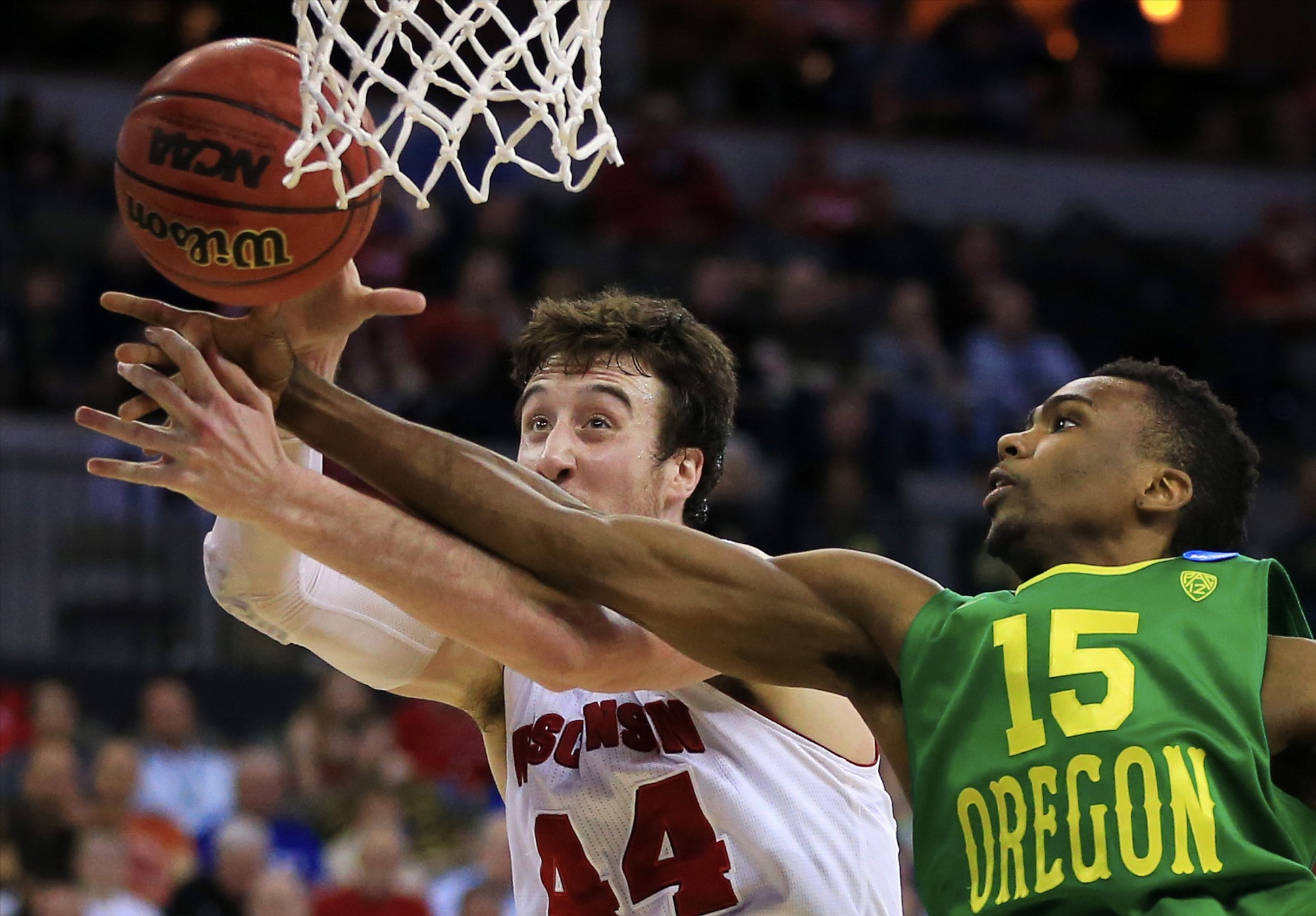 Oregon's Jalil Abdul-Bassit (15) and Wisconsin's Frank Kaminsky (44) compete for a rebound during the second half of an NCAA tournament game in Omaha, Neb., Sunday, March 22, 2015.