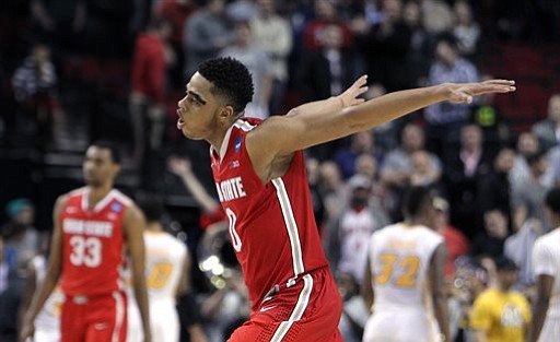 Ohio State guard D'Angelo Russell races toward his teammates after the buzzer in overtime in an NCAA second-round game against Virginia Commonwealth in Portland, Ore., Thursday.