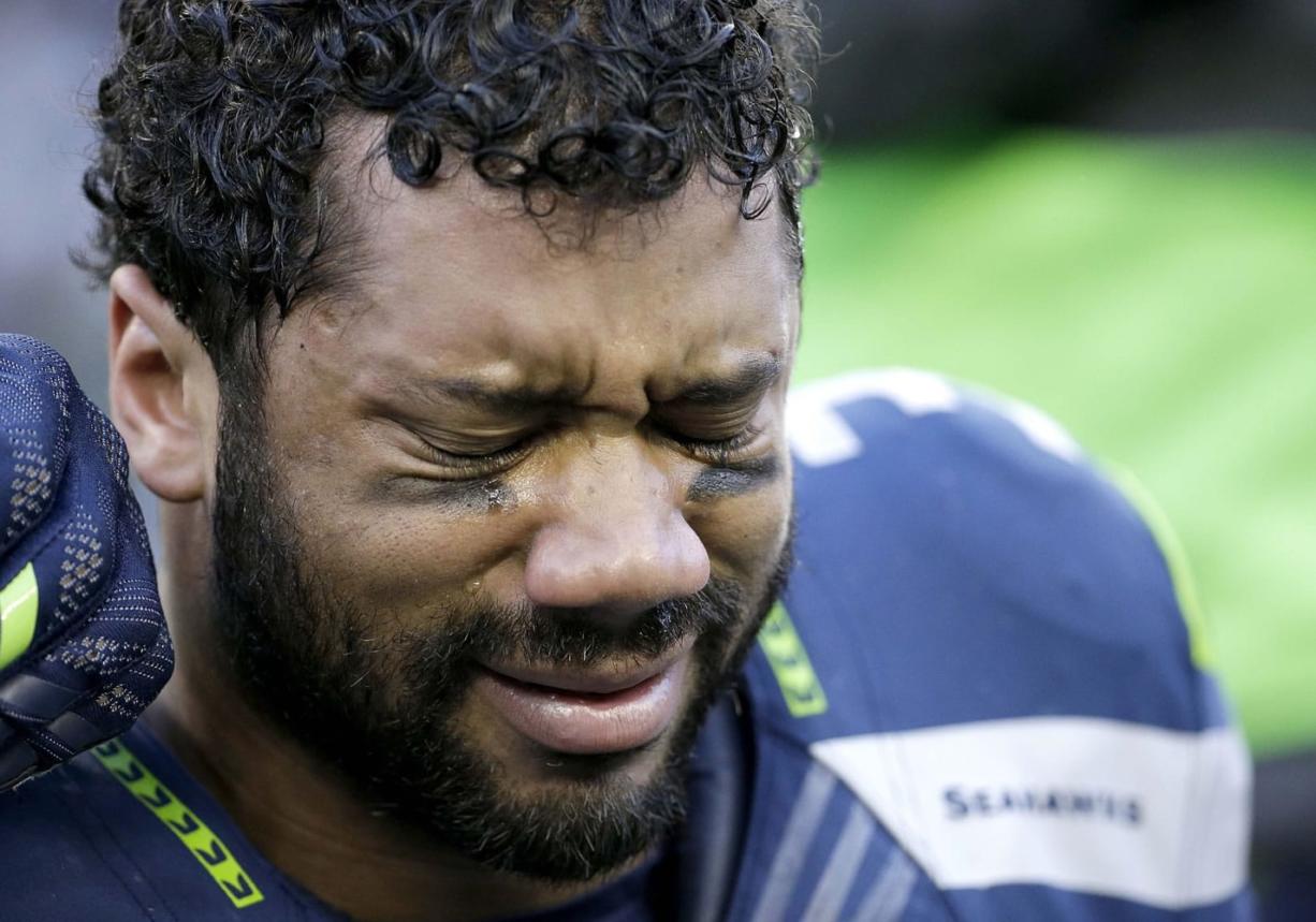 Seattle Seahawks quarterback Russell Wilson cries after winning NFC Championship game against the Green Bay Packers Sunday, Jan. 18, 2015, in Seattle.