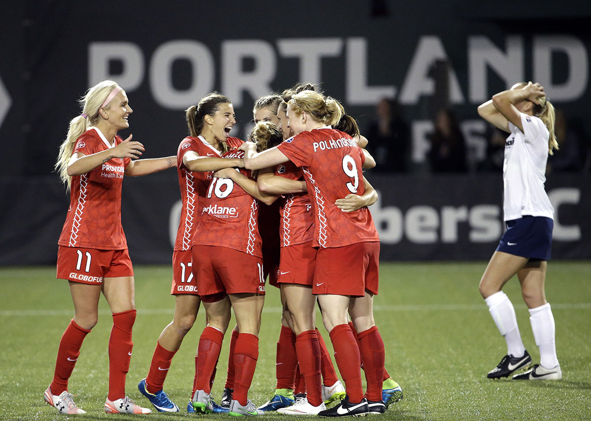 Portland Thorns players celebrate after Jodie Taylor scored the tying goal against the Washington Spirit during the second half of an NWSL soccer match in Portland, Ore., Sunday, Aug. 30, 2015. The teams tied 3-3.