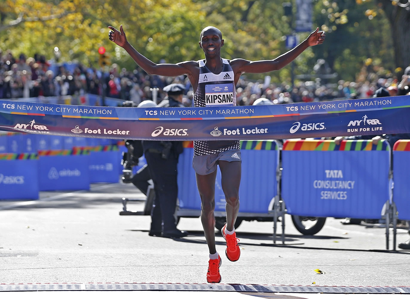 Wilson Kipsang of Kenya celebrates as he hits the tape to win the men's division of the the 44th annual New York City Marathon in New York, Sunday, Nov. 2, 2014. Kipsang won in an unofficial time of 2 hours, 10 minutes, 59 seconds.