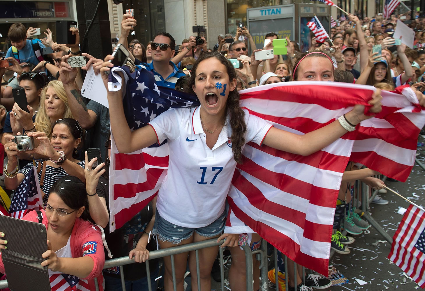Lucie Keleman of New York's Westchester County cheers as U.S. Women's World Cup soccer champions make their way up Broadway to City Hall, during a ticker tape parade honoring the team Friday in New York. (AP Photo/Bryan R.