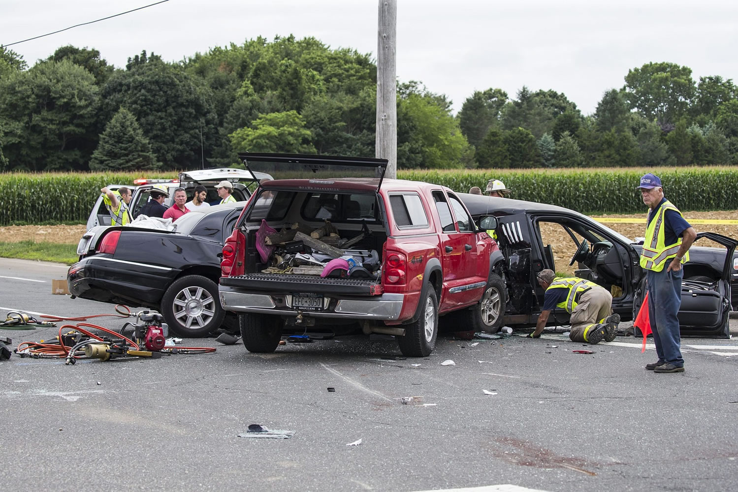 Authorities investigate the scene of a fatal crash between a limousine and a pickup truck Saturday in Cutchogue, N.Y.