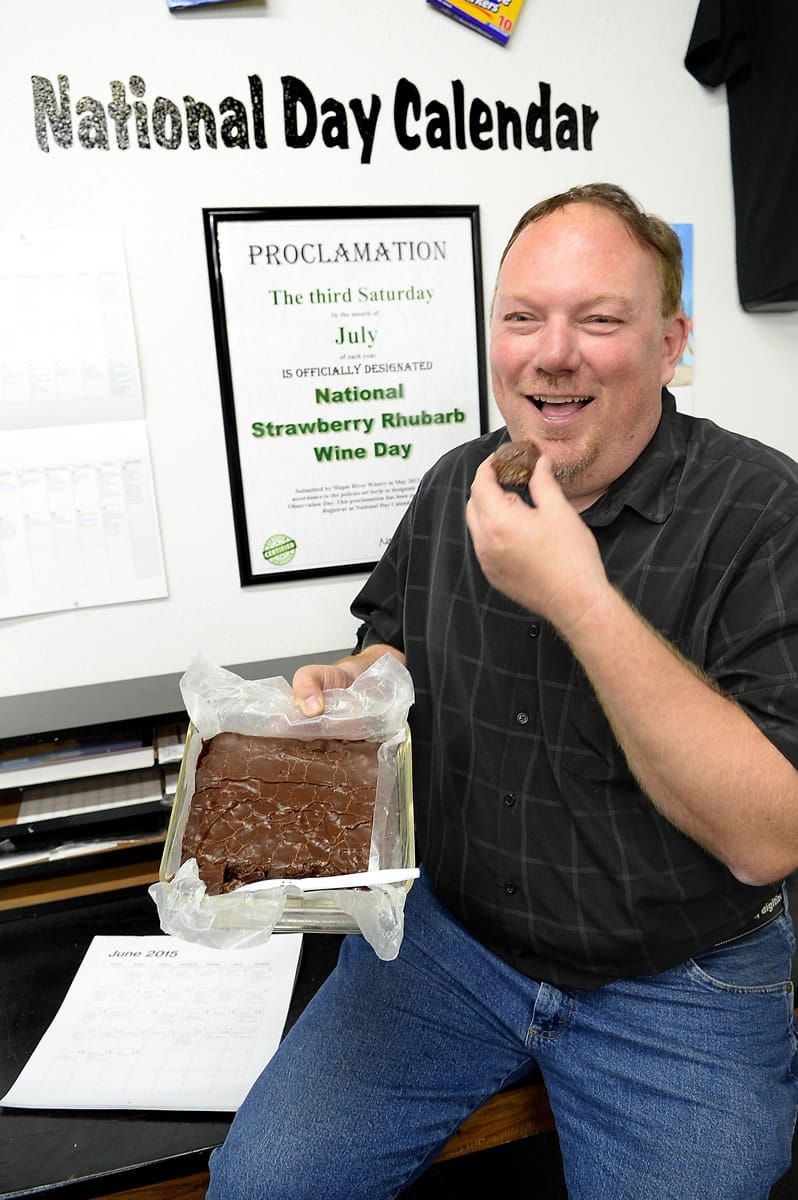 Zoovio co-owner Marlo Anderson eats some homemade fudge June 16 as he poses for photos on National Fudge Day at his Mandan, N.D., business.