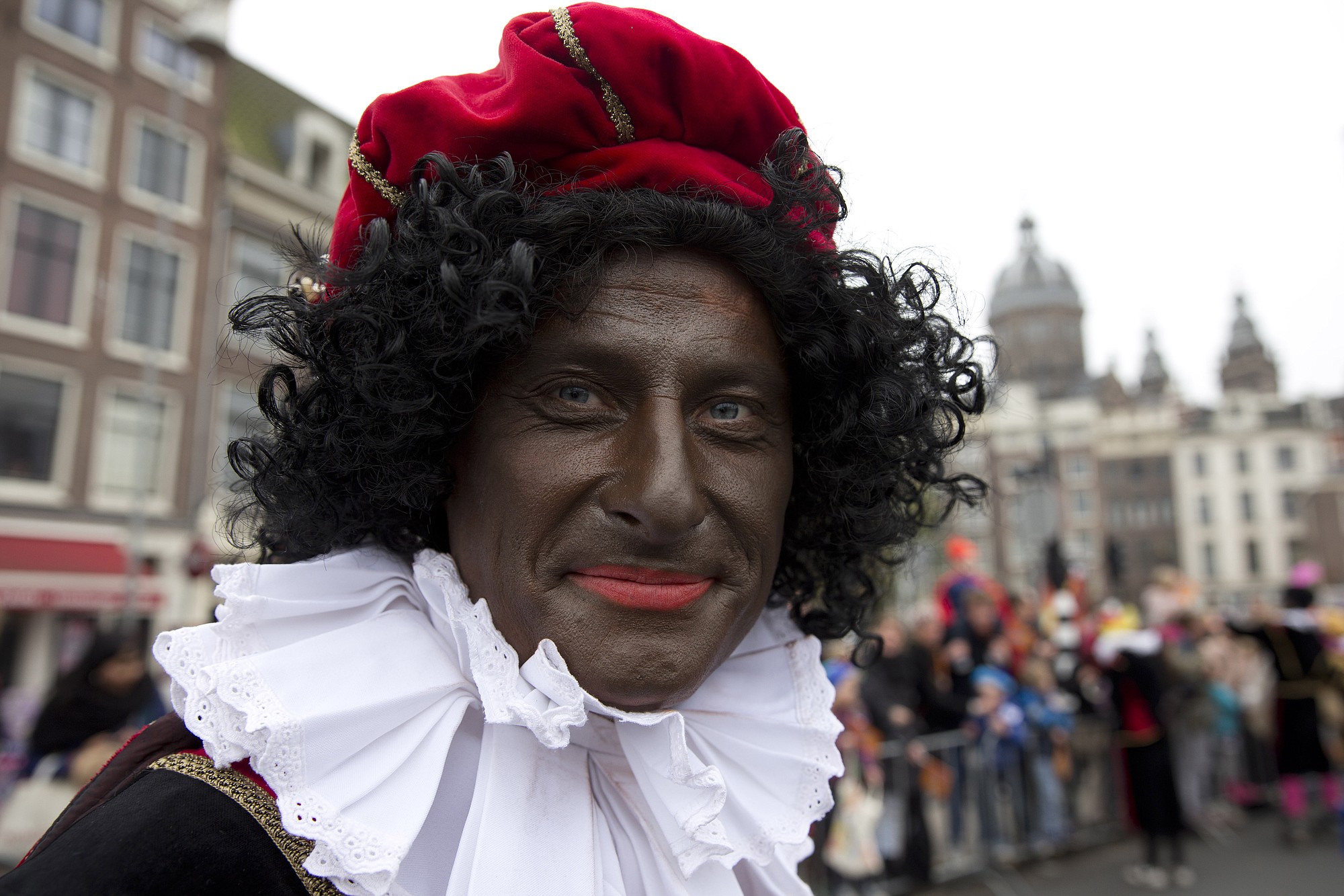 A man is dressed as &quot;Zwarte Piet,&quot; or Black Pete, the sidekick of the Dutch version of Santa Claus, at a 2013 parade in Amsterdam.