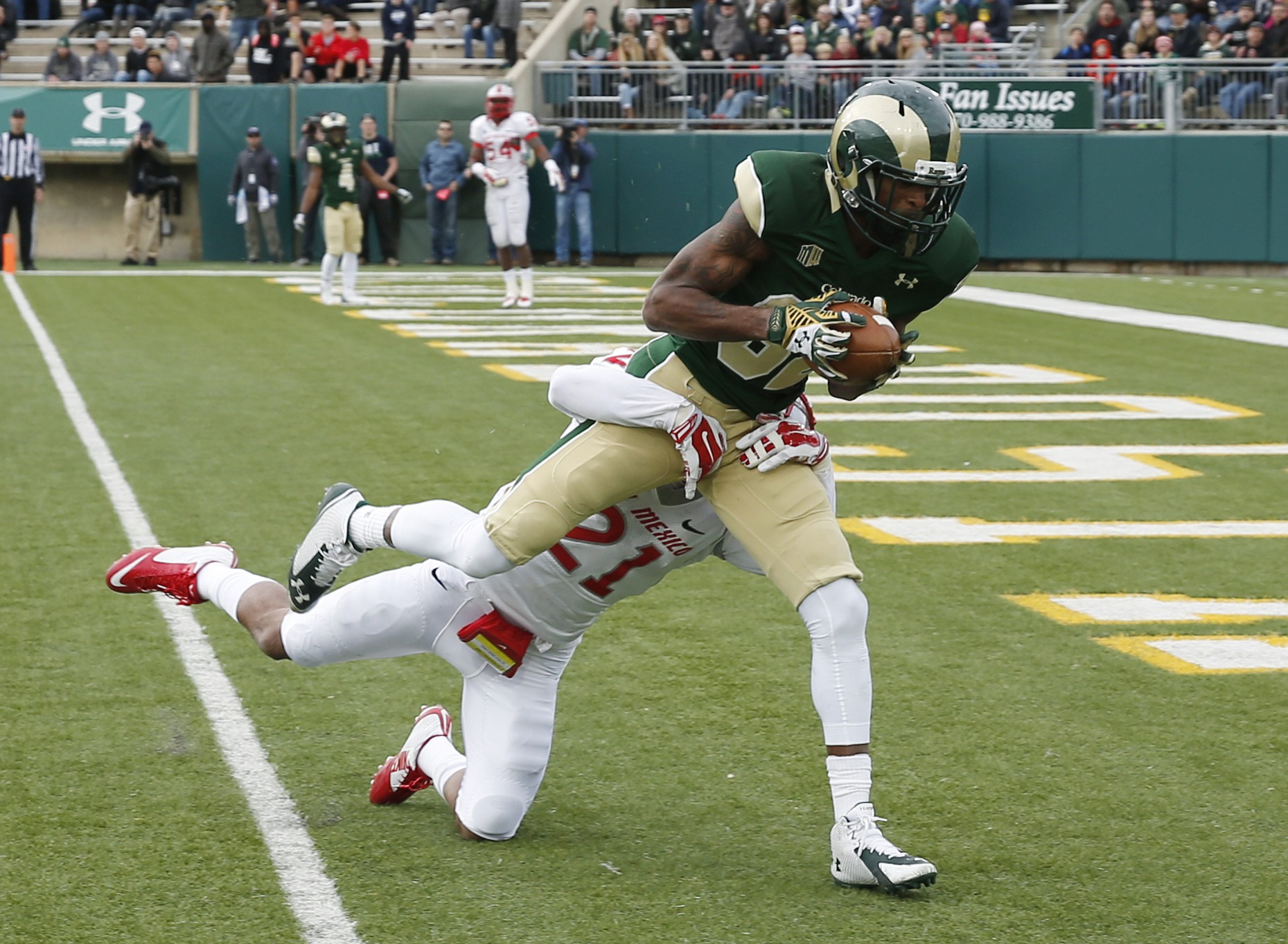 Colorado State wide receiver Rashard Higgins, front, drags New Mexico defensive back Donnie Duncan into the end zone for a touchdown after catching a pass from Garrett Grayson in the third quarter of Colorado State's 58-20 victory in Fort Collins, Colo., on Saturday, Nov. 22, 2014.