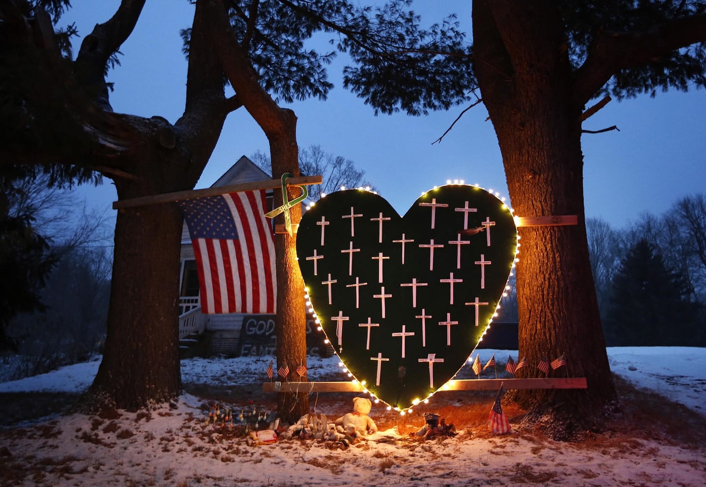 A makeshift memorial with crosses for the victims of the Sandy Hook Elementary School shooting massacre stands outside a home in Newtown, Conn., on the one-year anniversary of the shootings in 2013.