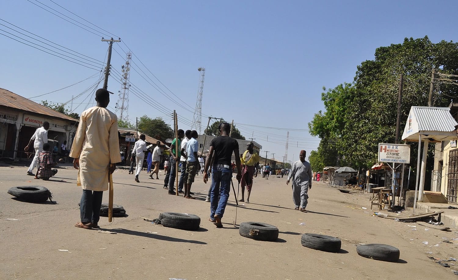 Vigilante barricade the road following an explosion at a market in Maiduguri, Nigeria, on Monday.