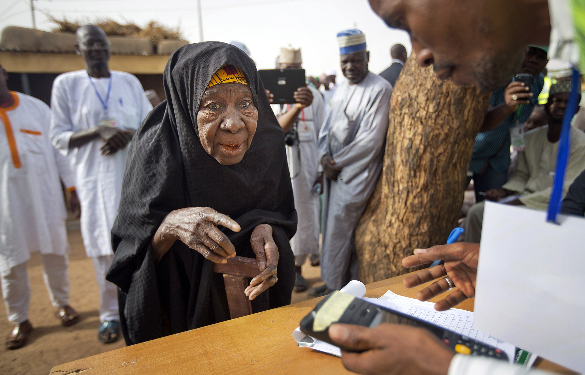 A woman presents her fingerprint to validate her voting card Saturday in Daura, Nigeria, prior to casting her vote in the presidential election.