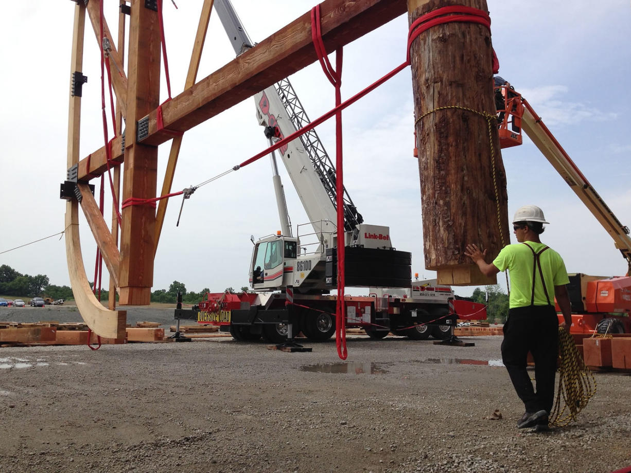 A wooden rib that is part of a ship based on the story of Noah's ark is raised into place Thursday in Williamstown, Ky.