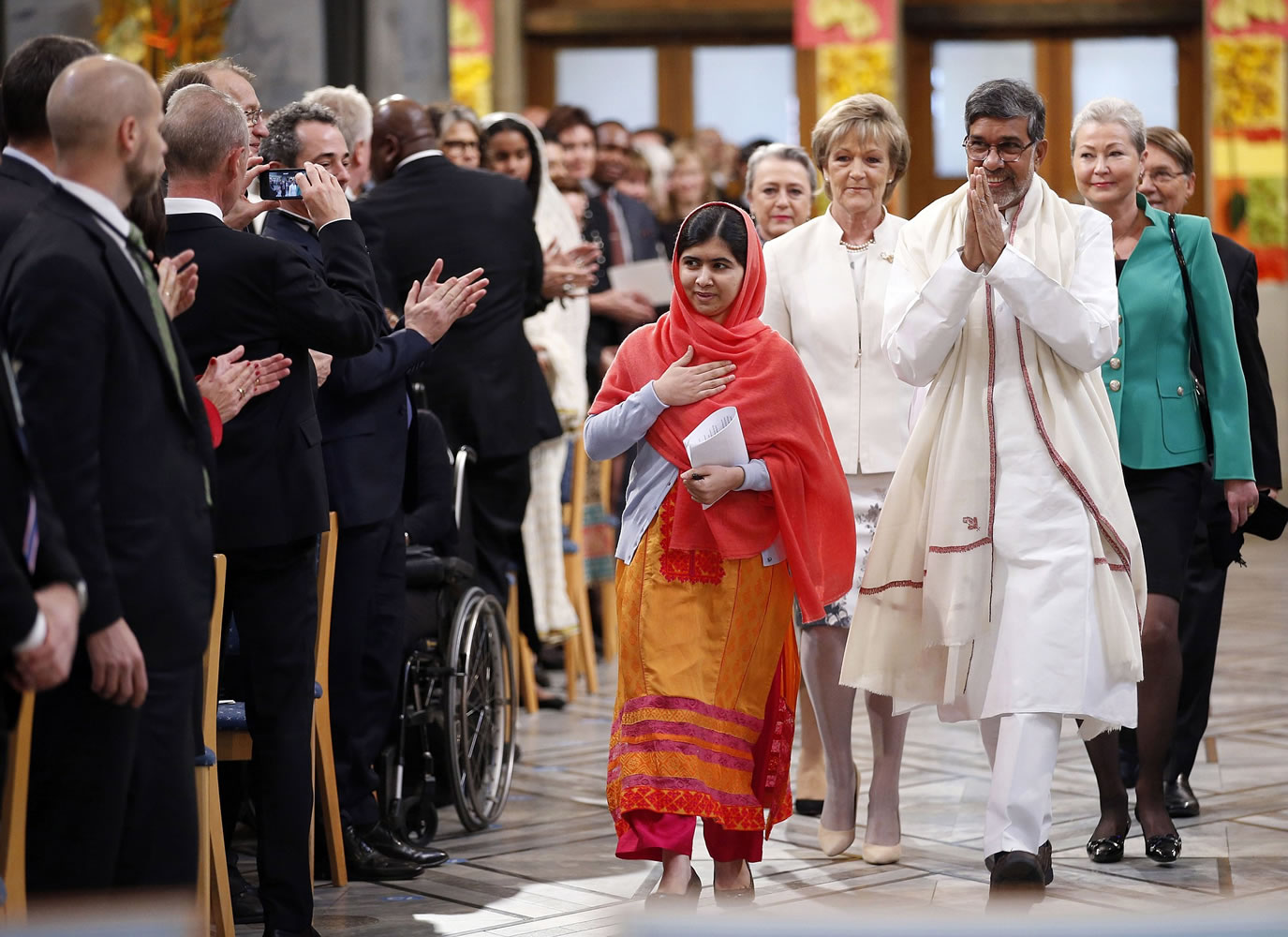 Nobel Peace Prize winners Malala Yousafzai, from Pakistan, center left, and Kailash Satyarthi, of India, arrive for the Nobel Peace Prize award ceremony in Oslo, Norway, on Wednesday.