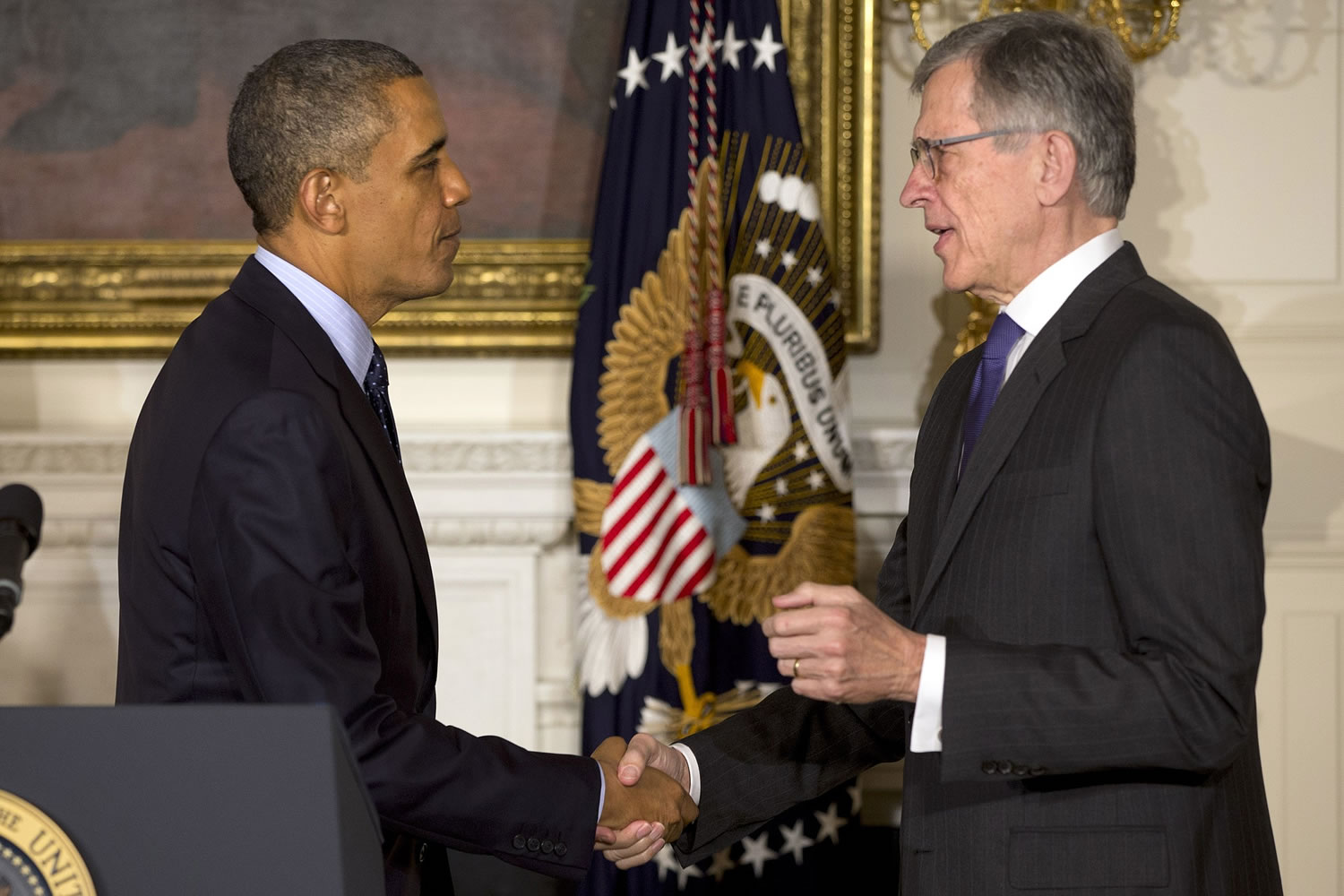 President Barack Obama shakes hands with then nominee for Federal Communications Commission, Tom Wheeler, in the State Dining Room of the White House in Washington.