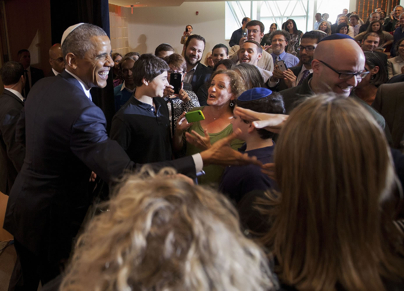 President Barack Obama greets people Friday after speaking at Adas Israel Congregation in Washington. The president addressed one of the largest Jewish congregations in Washington to highlight efforts to combat anti-Semitism, a problem he says has created an intimidating environment worldwide for Jewish families.